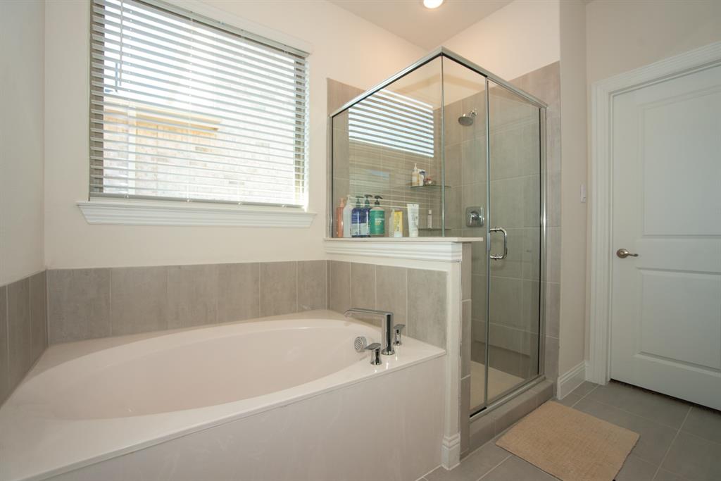 3813 Oldham Road Little Elm, TX 75068 - Photo 16 of 27 Full bathroom featuring a stall shower, light tile patterned floors, and a bath