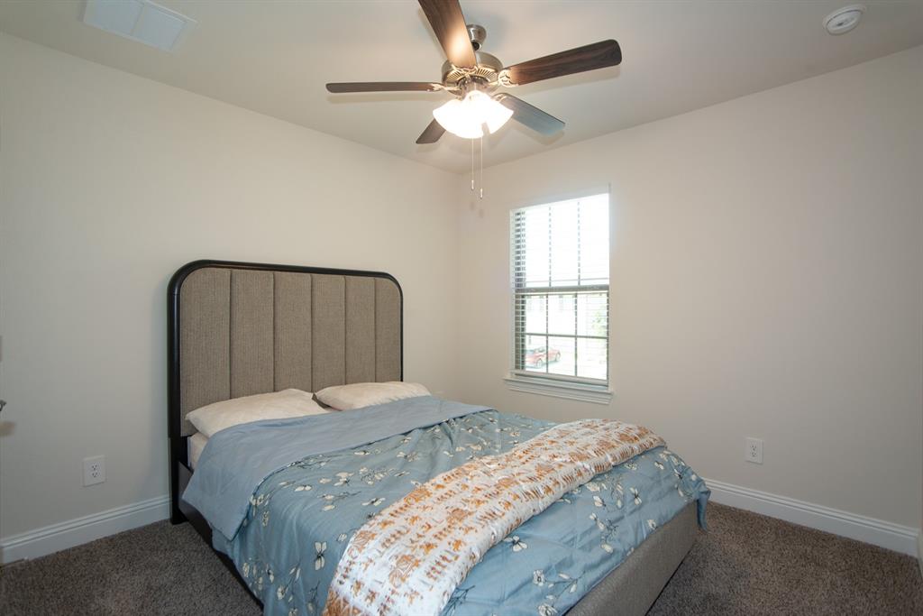 3813 Oldham Road Little Elm, TX 75068 - Photo 20 of 27 Carpeted bedroom featuring baseboards and a ceiling fan