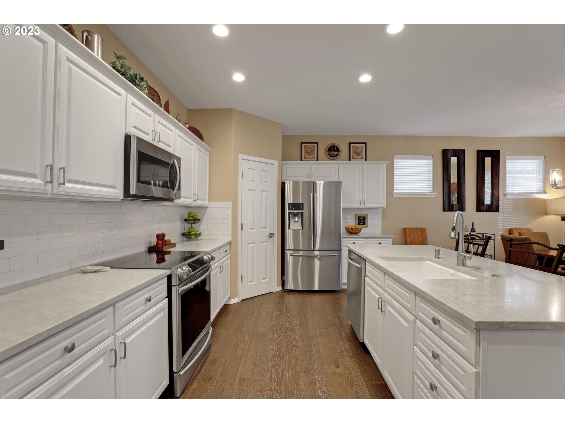 10698 Southwest Washington Street Portland, OR 97225 - Photo 11 of 25 a kitchen with stainless steel appliances granite countertop a sink stove and refrigerator