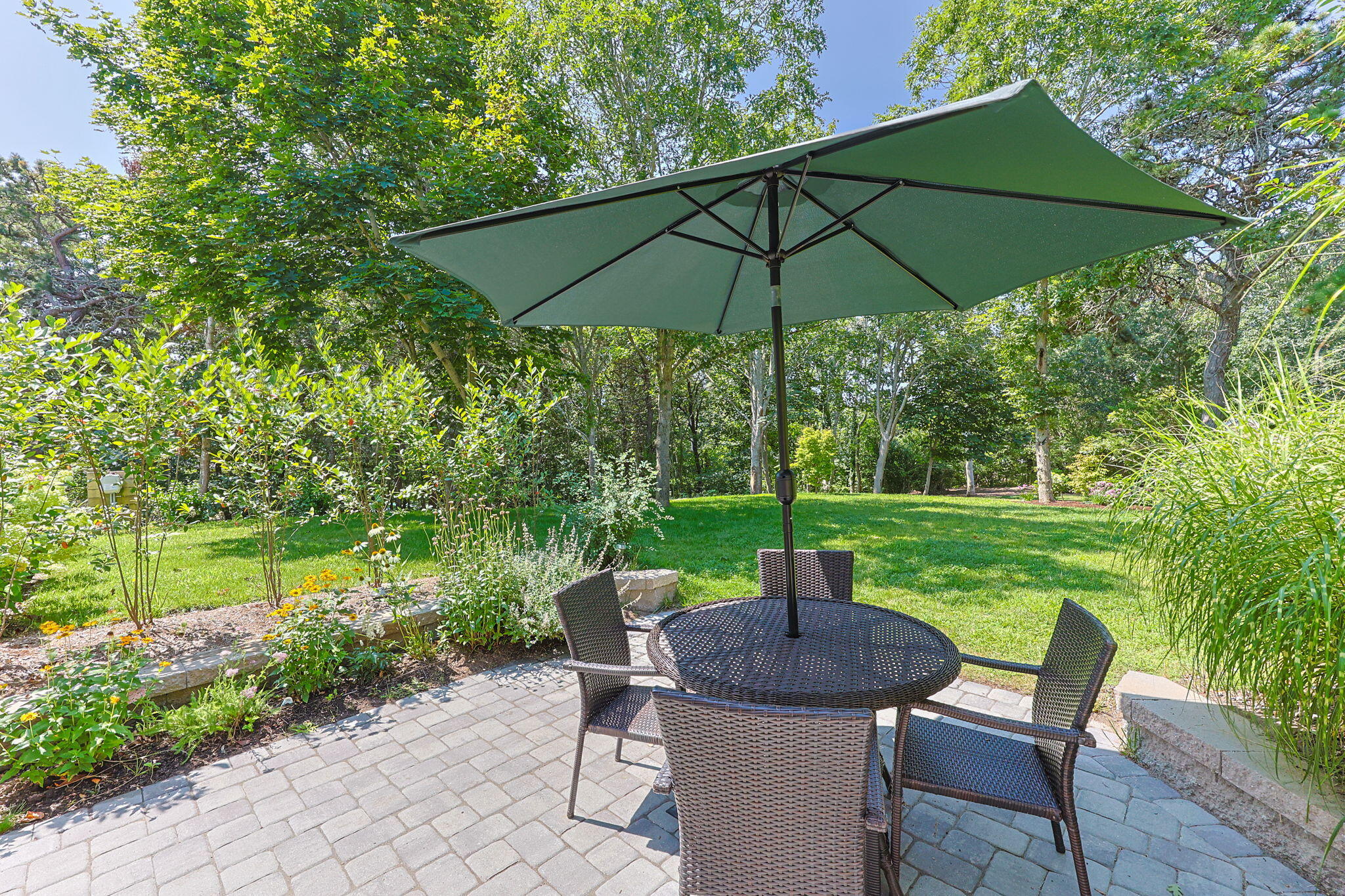 58 Stepping Stones Road Chatham, MA 02633 - Photo 41 of 52 a view of a table and chairs under an umbrella