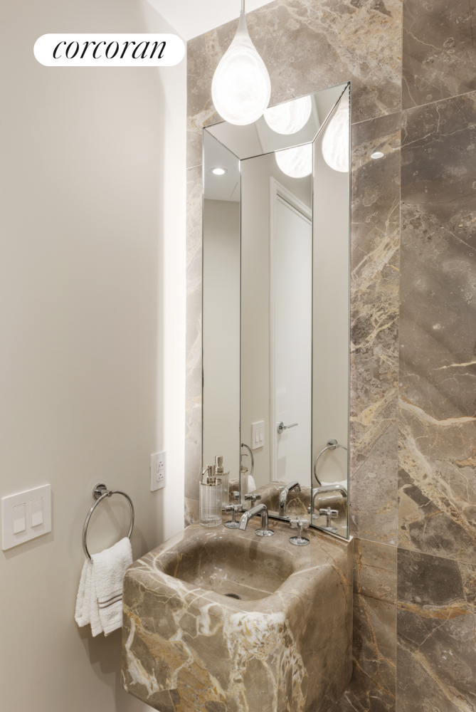 430 East 58th Street, Unit 19B Manhattan, NY 10022 - Photo 4 of 20 a bathroom with a double vanity sink and a mirror