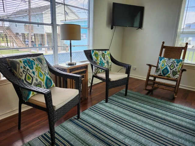 a living room with furniture and wooden floor