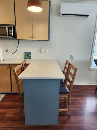 a bathroom with a granite countertop toilet sink and mirror