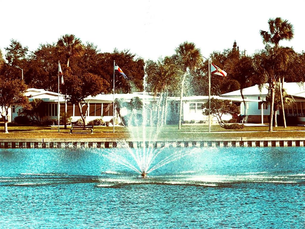 1100 South Belcher Road, Unit 508 Largo, FL 33771 - Photo 25 of 37 a view of swimming pool with a garden and trees