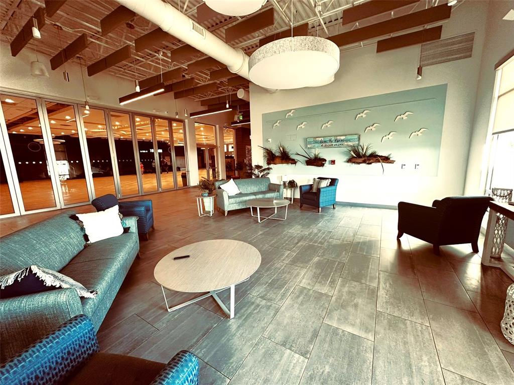 1100 South Belcher Road, Unit 508 Largo, FL 33771 - Photo 34 of 37 a living room with furniture a rug and a chandelier