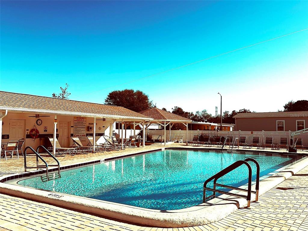 1100 South Belcher Road, Unit 508 Largo, FL 33771 - Photo 5 of 37 a view of a swimming pool with outdoor seating