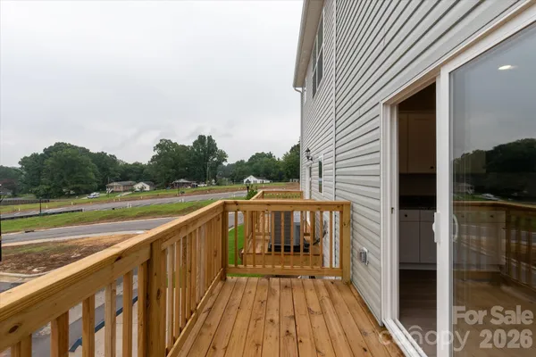 a view of balcony with wooden floor and fence
