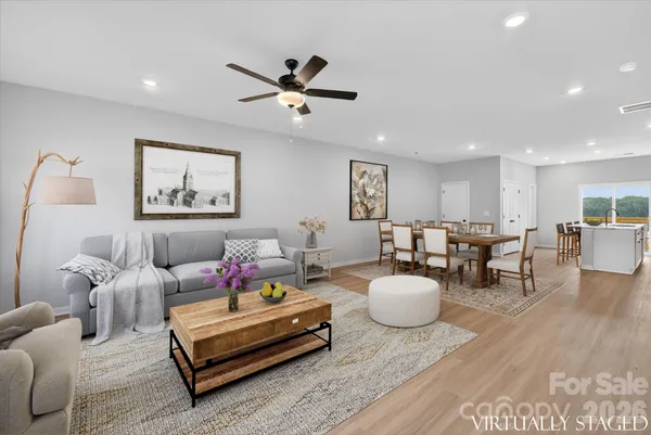 a living room with furniture and wooden floor