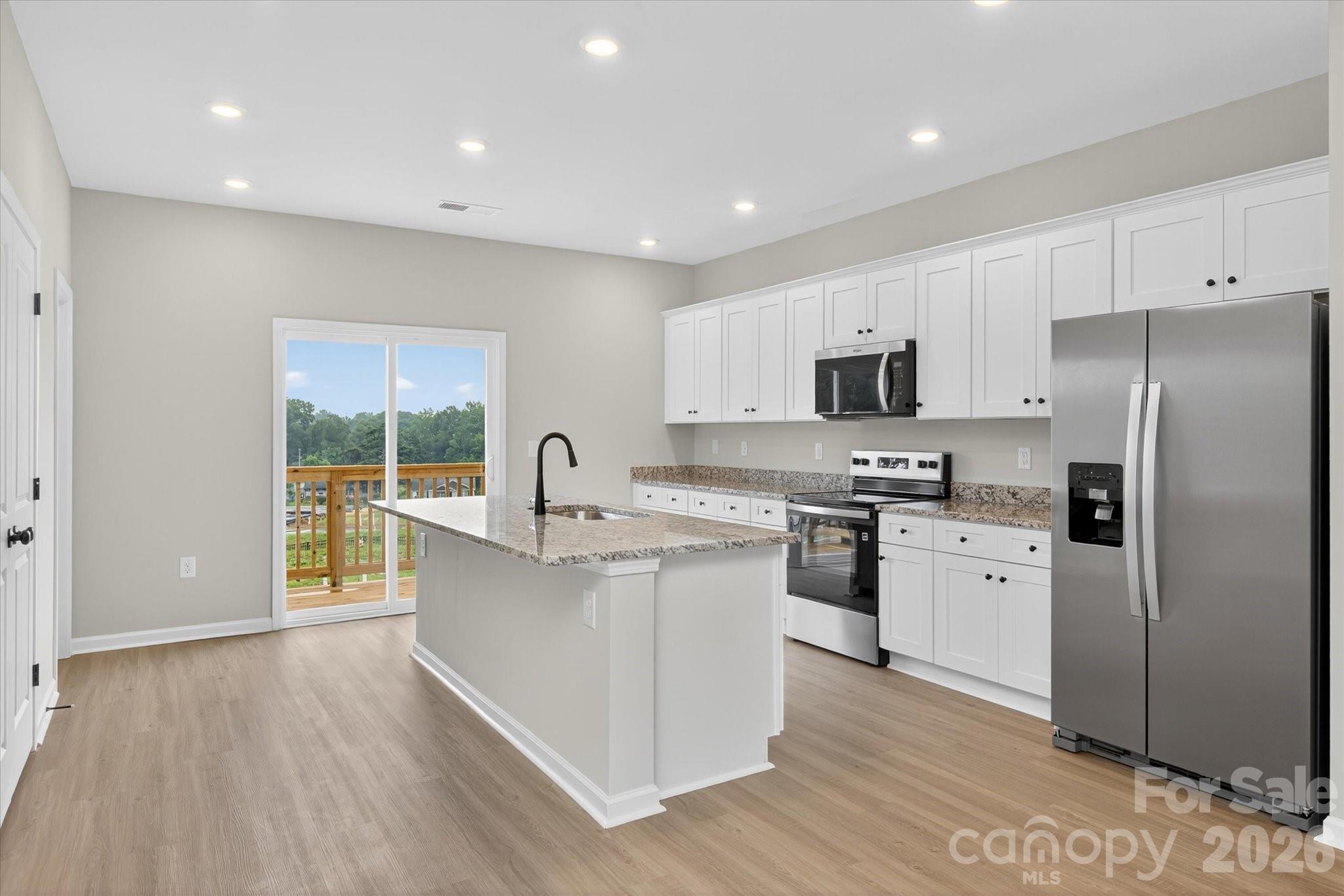 1850 Rhyne Elementary Drive Gastonia, NC 28052 - Photo 8 of 20 a large kitchen with cabinets wooden floor and stainless steel appliances