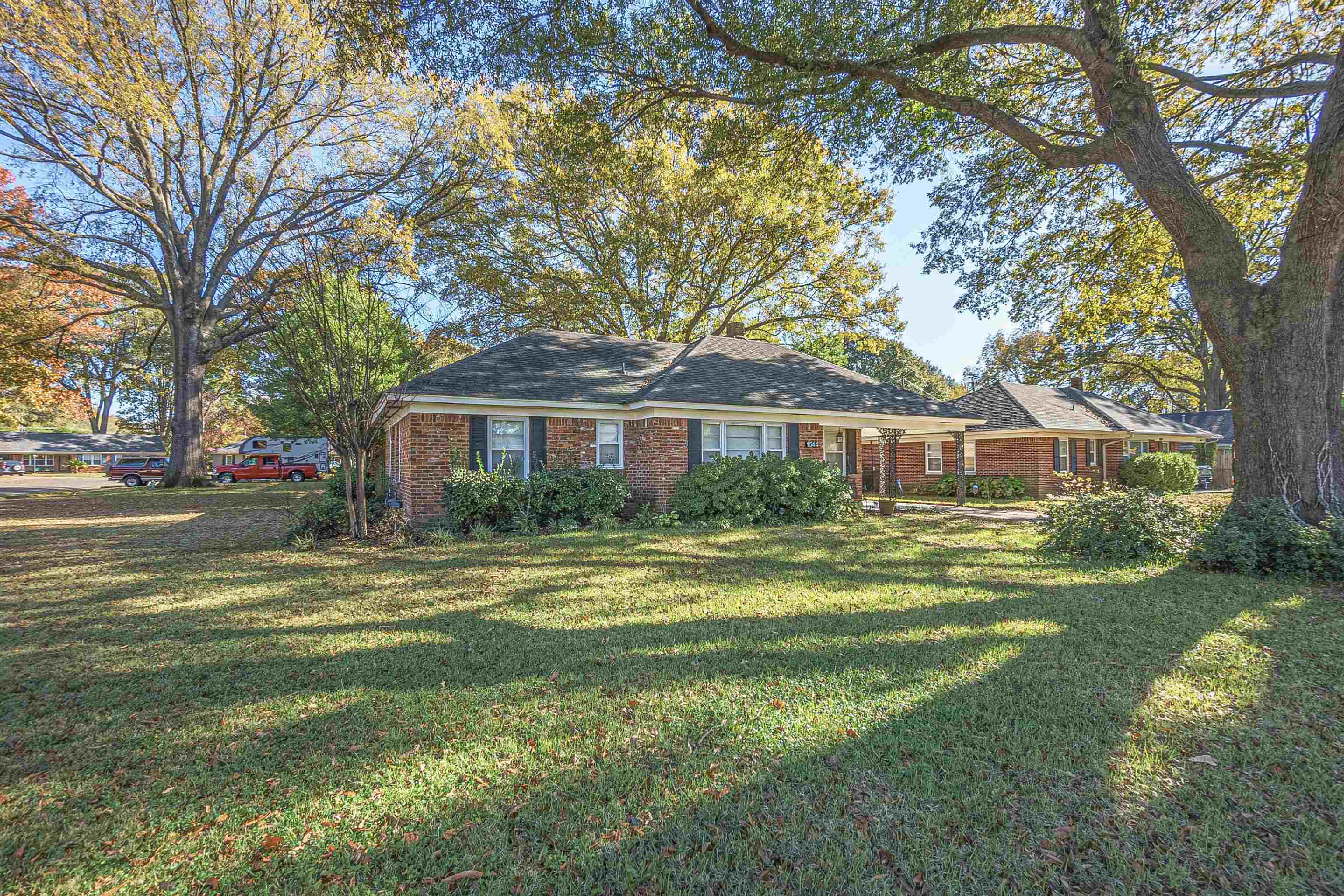 1544 Whitewater Road Memphis, TN 38117 - Photo 1 of 18 a front view of a house with a garden