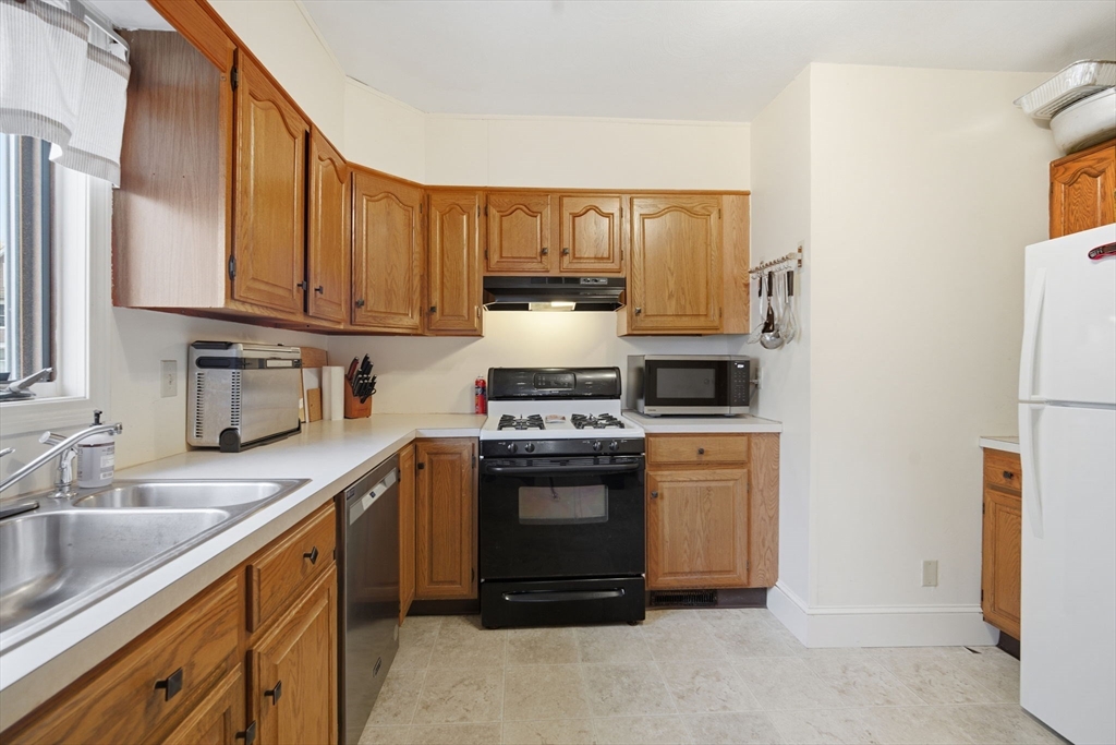122 Hastings Street Springfield, MA 01104 - Photo 11 of 29 a kitchen with a stove and a refrigerator