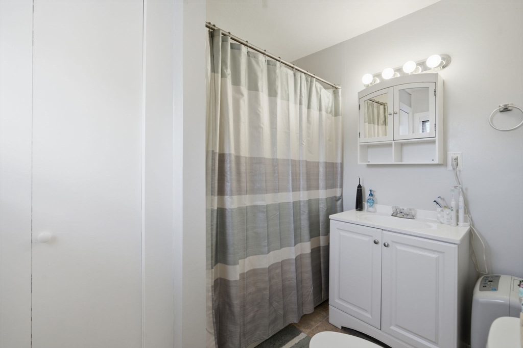 122 Hastings Street Springfield, MA 01104 - Photo 13 of 29 a bathroom with a sink a toilet and shower