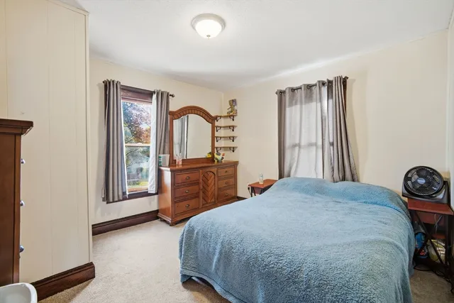 a bedroom with a bed and a dresser