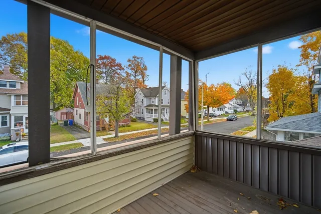a view of a porch with a table and chairs
