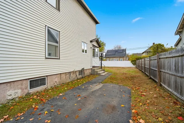a view of a house with wooden fence