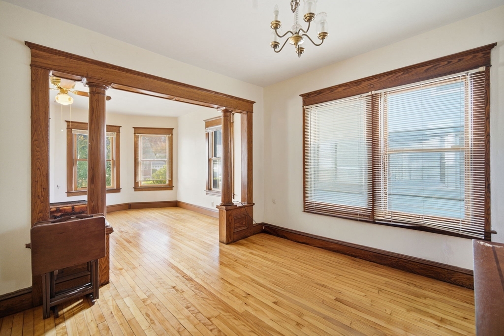 122 Hastings Street Springfield, MA 01104 - Photo 3 of 29 a view of an empty room with a window and wooden floor