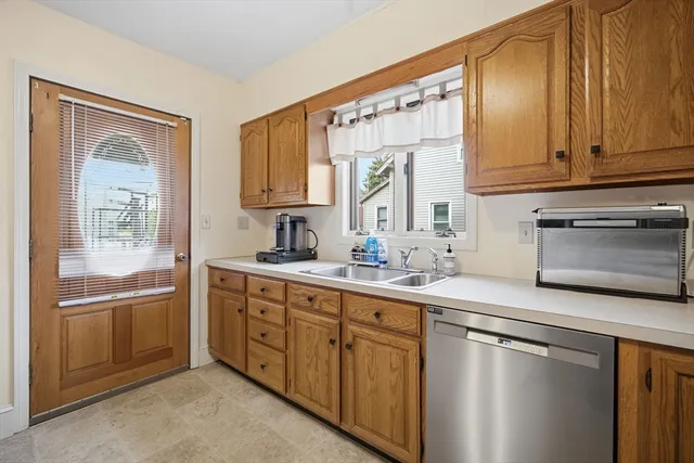 a kitchen with stainless steel appliances granite countertop a sink and cabinets with wooden floor