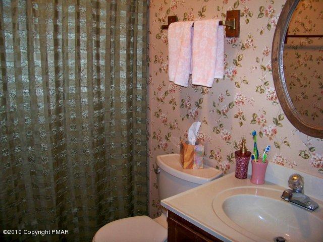 F2 Monomonock Road Cresco, PA 18326 - Photo 11 of 13 a bathroom with a sink a toilet and shower curtain