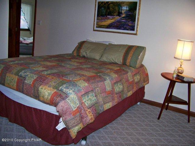F2 Monomonock Road Cresco, PA 18326 - Photo 10 of 13 a bedroom with a bed and a lamp on table