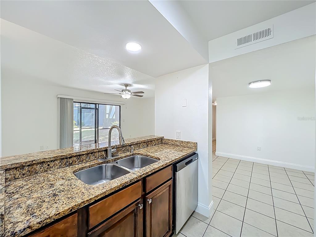 185 Waterfall Way, Unit 102 Altamonte Springs, FL 32714 - Photo 26 of 59 a kitchen that has a sink and a granite counter tops