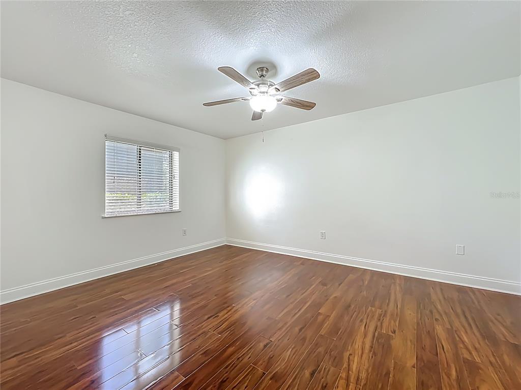 185 Waterfall Way, Unit 102 Altamonte Springs, FL 32714 - Photo 32 of 59 a view of an empty room with window and wooden floor