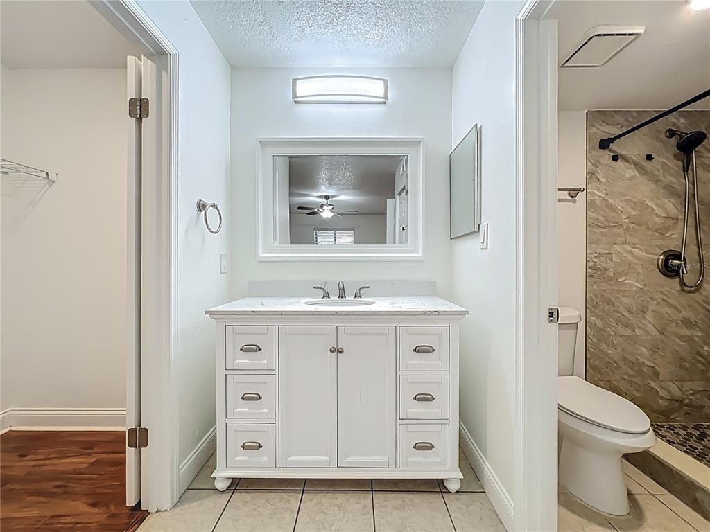 185 Waterfall Way, Unit 102 Altamonte Springs, FL 32714 - Photo 36 of 59 a bathroom with a granite countertop sink toilet and shower