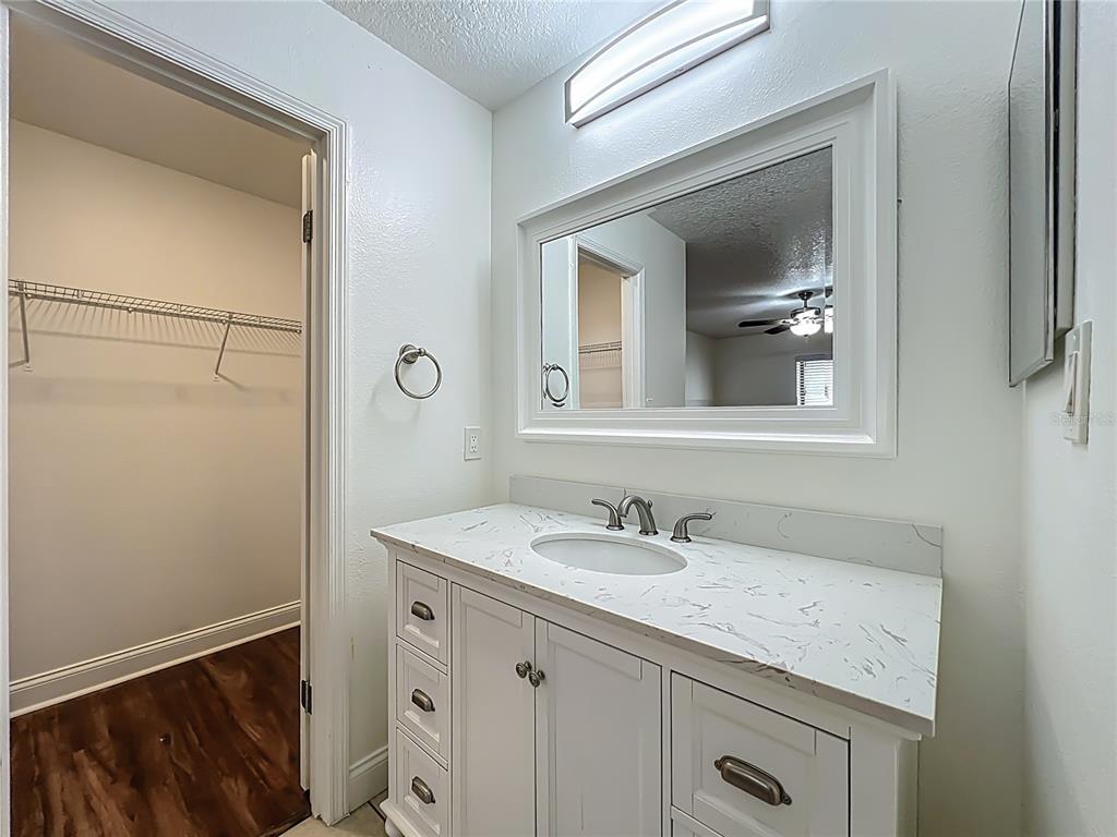 185 Waterfall Way, Unit 102 Altamonte Springs, FL 32714 - Photo 37 of 59 a bathroom with a granite countertop sink and a mirror