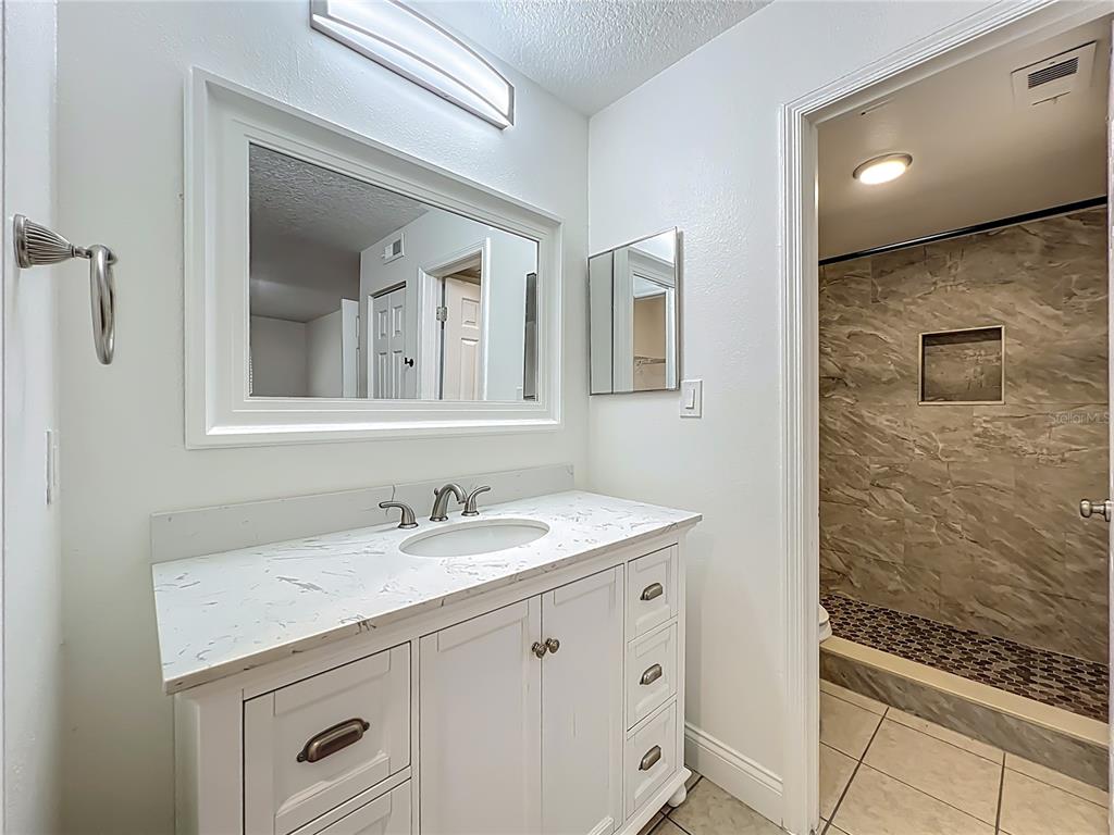 185 Waterfall Way, Unit 102 Altamonte Springs, FL 32714 - Photo 39 of 59 a bathroom with a sink and a mirror