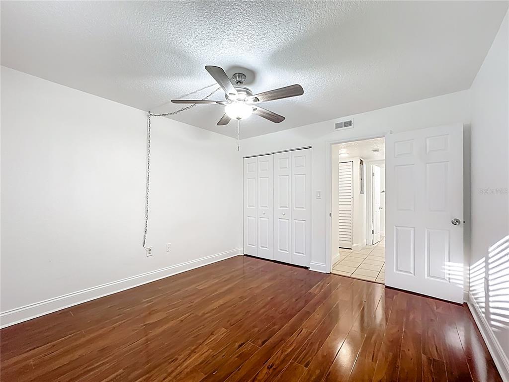 185 Waterfall Way, Unit 102 Altamonte Springs, FL 32714 - Photo 44 of 59 a view of an empty room with wooden floor