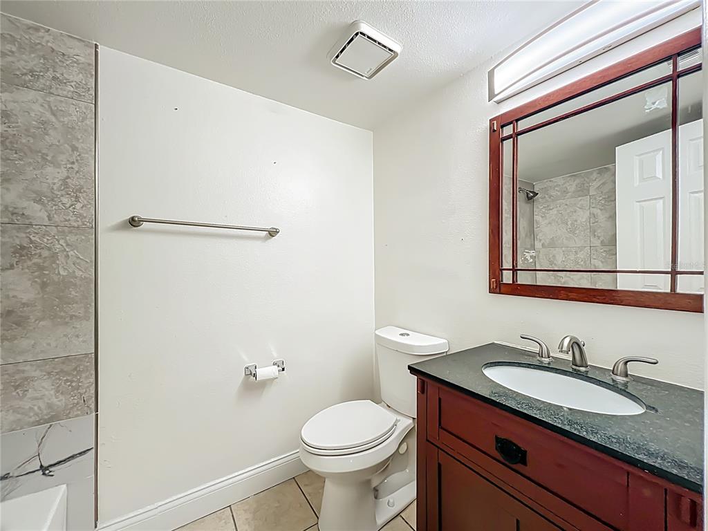 185 Waterfall Way, Unit 102 Altamonte Springs, FL 32714 - Photo 47 of 59 a bathroom with a granite countertop toilet sink and mirror