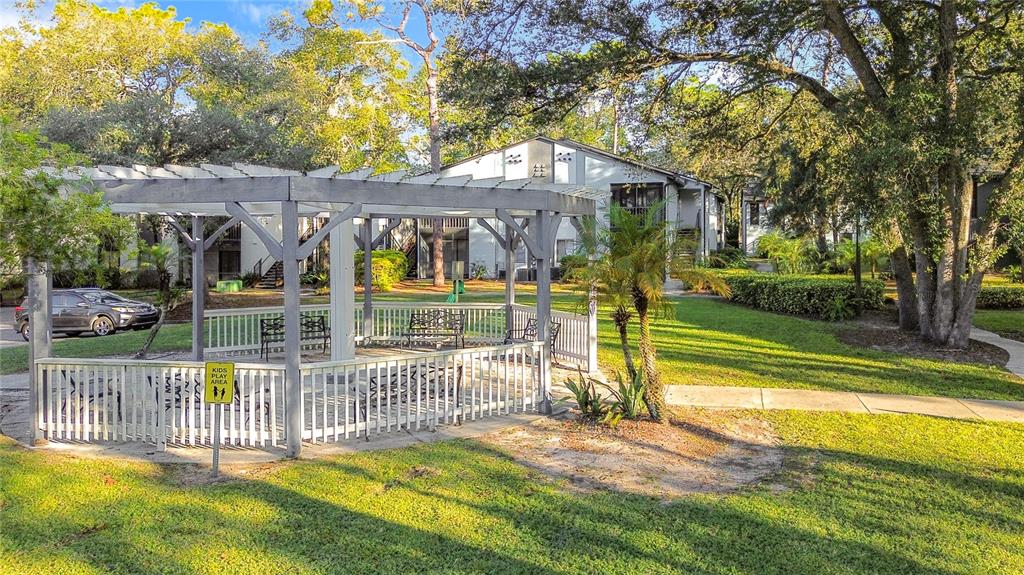 185 Waterfall Way, Unit 102 Altamonte Springs, FL 32714 - Photo 56 of 59 a view of a house with a swimming pool and a yard