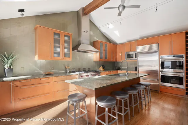 a kitchen with stainless steel appliances granite countertop a stove and a sink