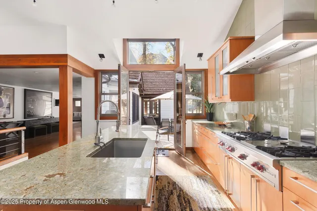a view of a hallway with workspace and living room