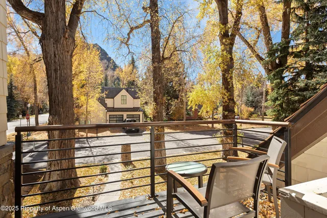 a bedroom with a bed and large windows