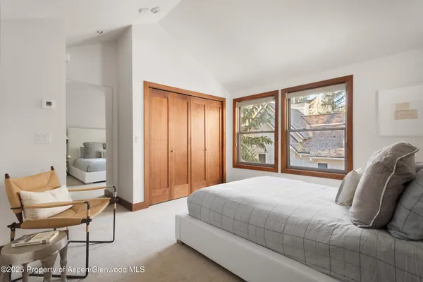 a bedroom with furniture and a large window