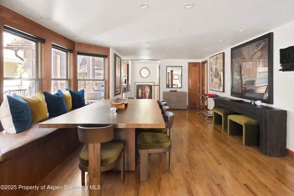 a kitchen with stainless steel appliances granite countertop a stove a sink dishwasher and a refrigerator with wooden floor