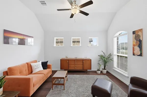 a living room with furniture and a potted plant