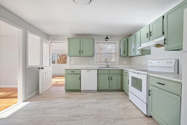a kitchen with a sink stove and cabinets