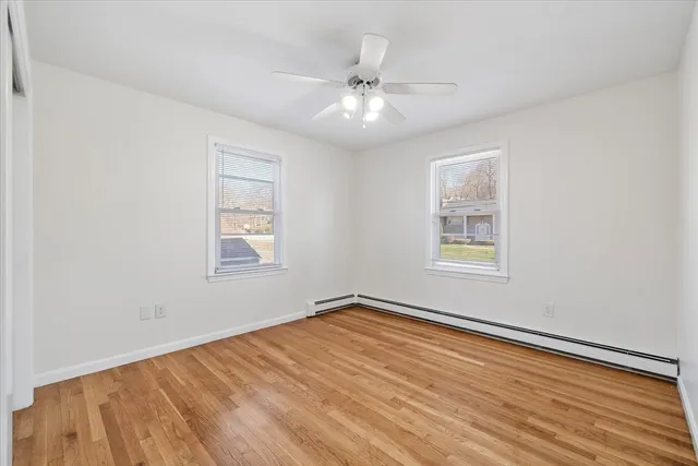 wooden floor in an empty room with a window