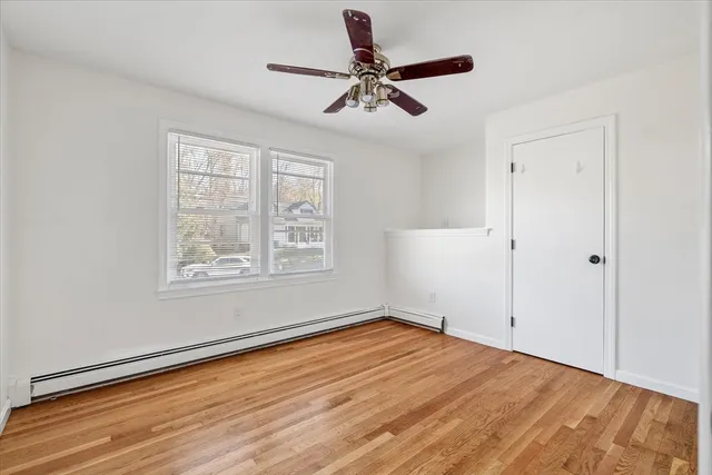 wooden floor in an empty room with a window