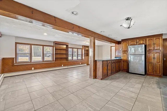 a view of a kitchen with refrigerator and a stove