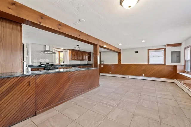 a view of kitchen with stainless steel appliances granite countertop lots of counter top space