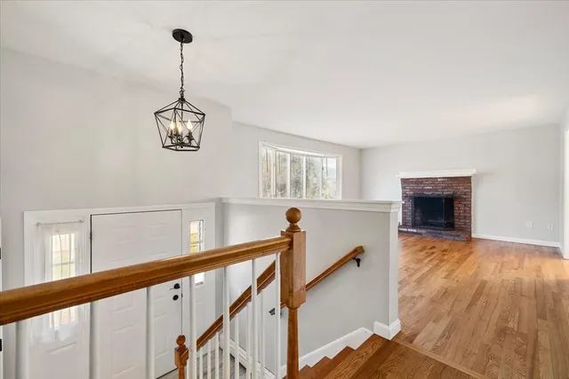 a view of a livingroom with furniture wooden floor windows and a chandelier