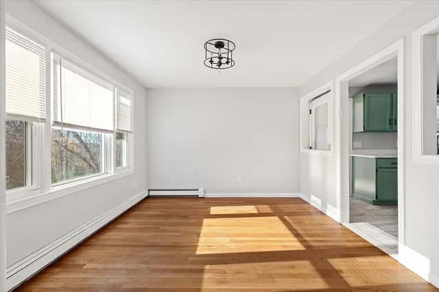 a view of a room with window and wooden floor