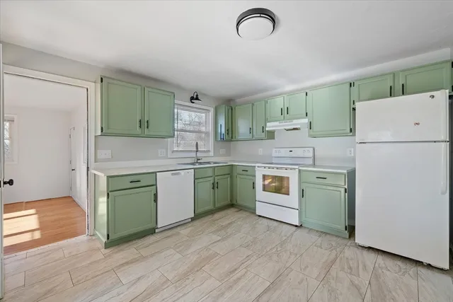 a kitchen with a white cabinets and white appliances