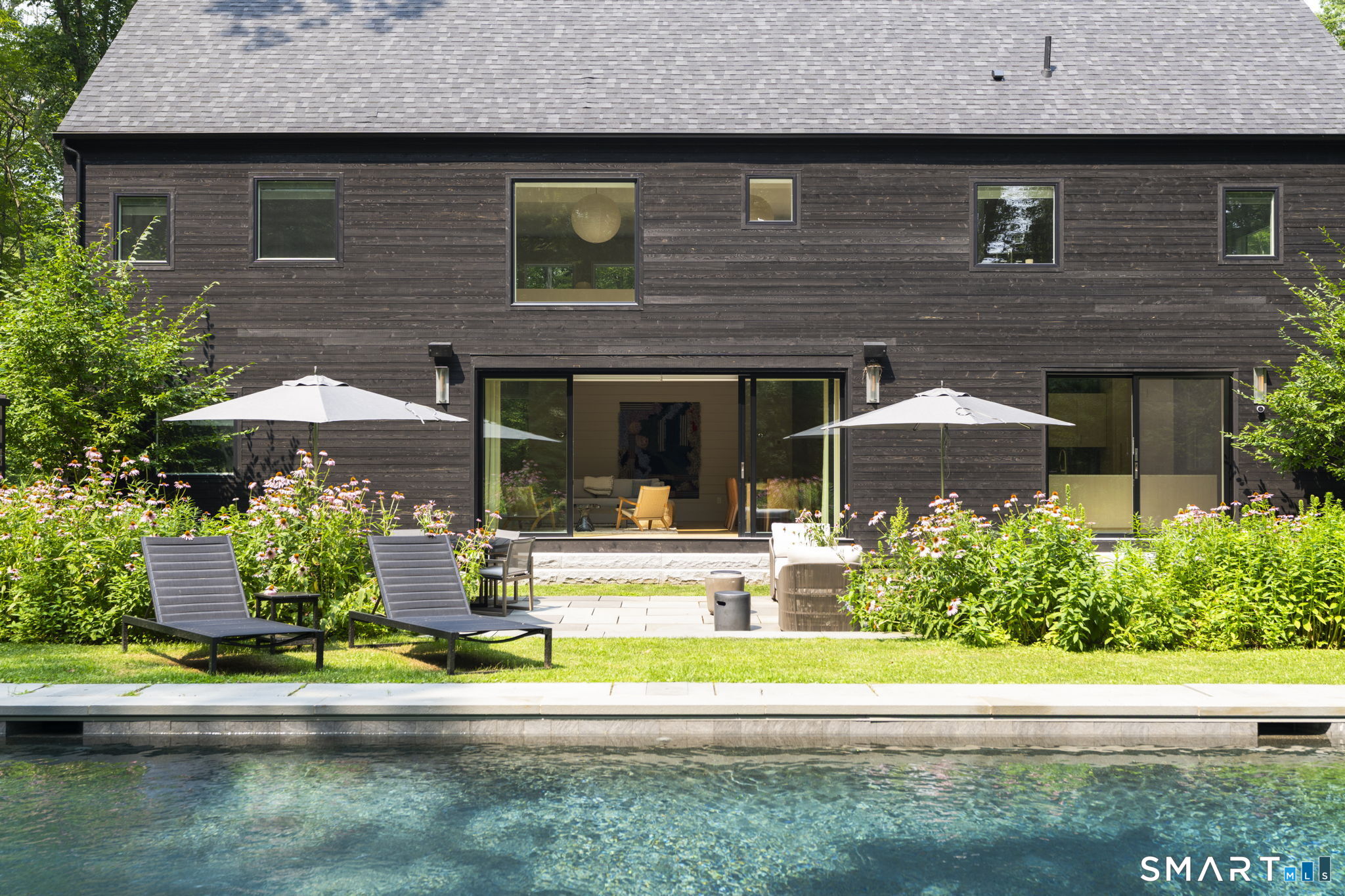 60 Selleck Hill Road Salisbury, CT 06068 - Photo 25 of 32 a front view of a house with a yard table and chairs