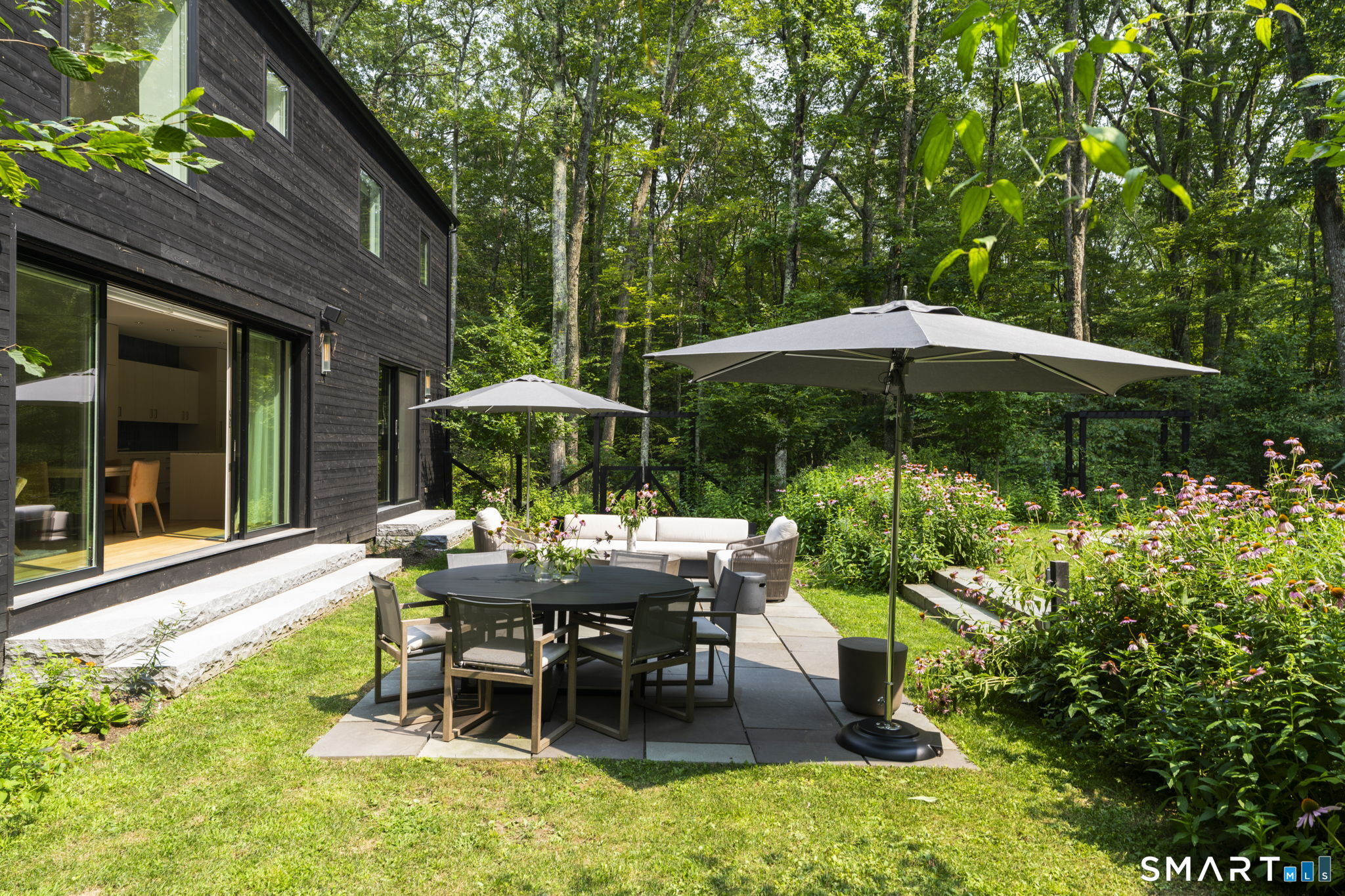 60 Selleck Hill Road Salisbury, CT 06068 - Photo 28 of 32 a view of backyard with table and chairs under an umbrella