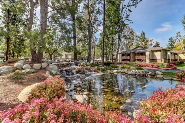 a view of a lake with a house and a yard