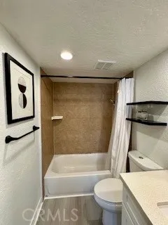 a bathroom with a toilet and a bathtub
