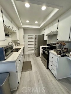 20702 El Toro, Unit 239 Lake Forest, CA 92630 - Photo 5 of 27 a kitchen with stainless steel appliances a stove a sink and a refrigerator